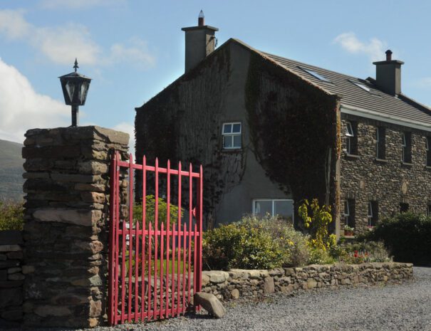 Entrance of An Riasc Bed and Breakfast in Dingle Peninsula with pink gate and stone wall